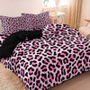 A pink and black leopard print duvet cover set displayed on a bed.