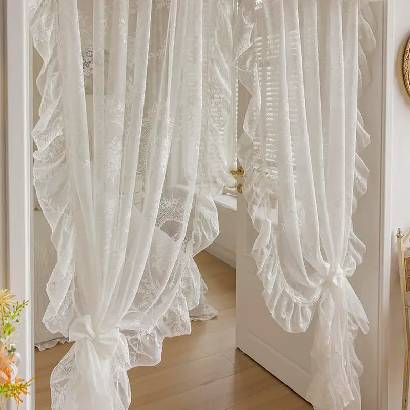 White French Rococo vintage lace curtains hanging in a doorway