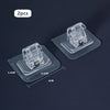 Two clear plastic nail-free adjustable curtain rod hooks displayed on a dark surface.
