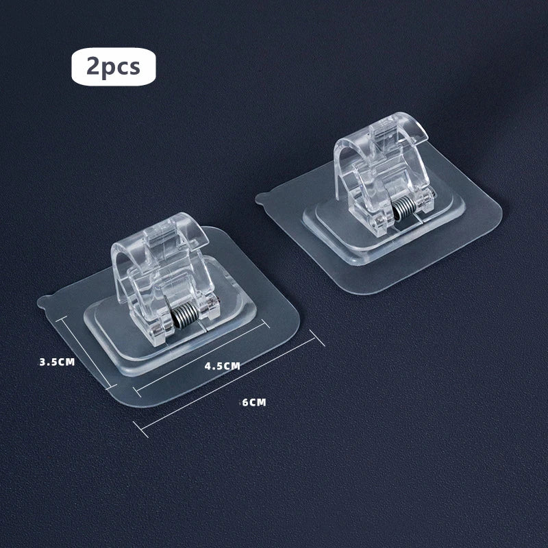 Two clear plastic nail-free adjustable curtain rod hooks displayed on a dark surface.
