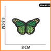 Set of five embroidered butterfly and rose iron-on patches, green with yellow accents.