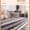 A close-up of a bed dressed with gray striped plush bedding and pillows.