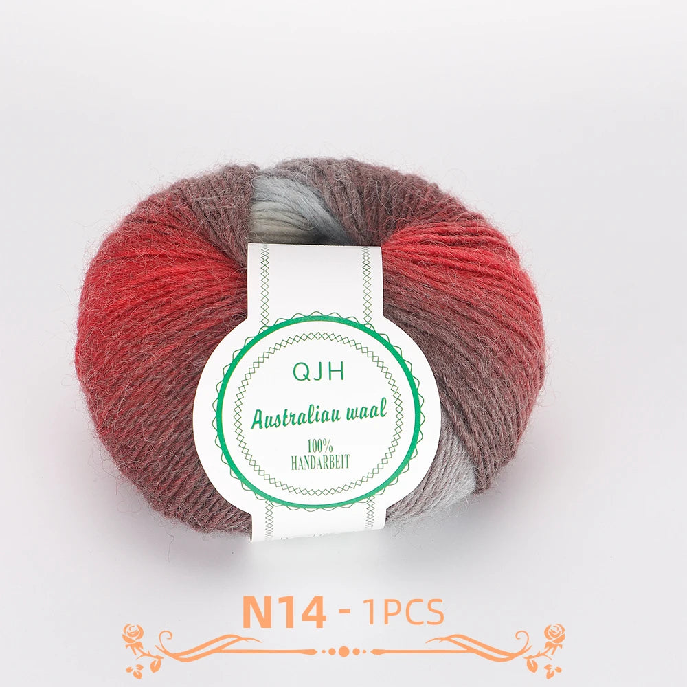 A ball of multi-colored wool yarn in shades of red, gray, and beige, labeled QJH Australiau waal.