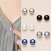 A collection of pearl and black button pins in various shades and finishes for DIY decoration.