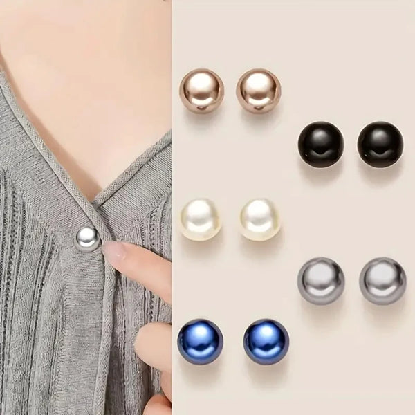 A collection of pearl and black button pins in various shades and finishes for DIY decoration.