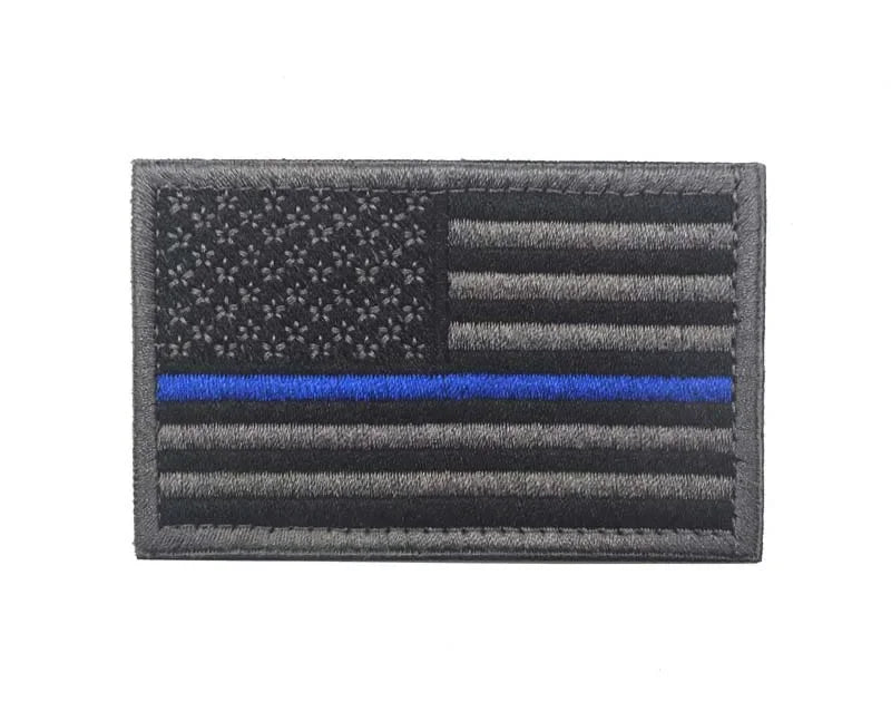 A rectangular flag patch featuring the design of the American flag and horizontal stripes in gray and blue.