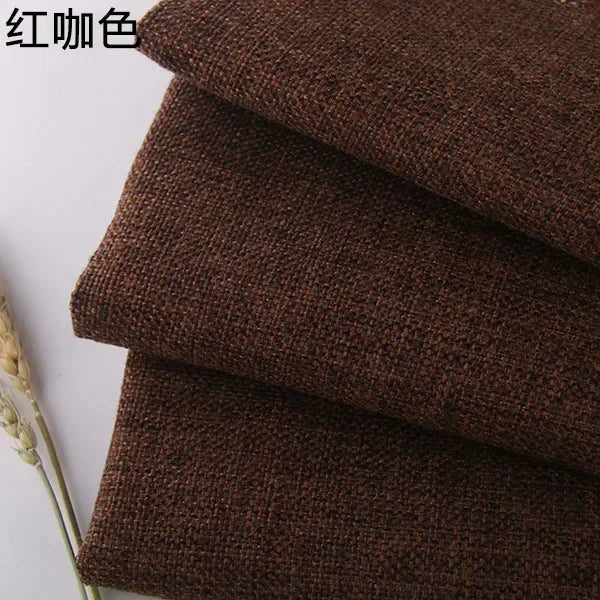 Stack of dark brown coarse linen or cotton fabric rolls