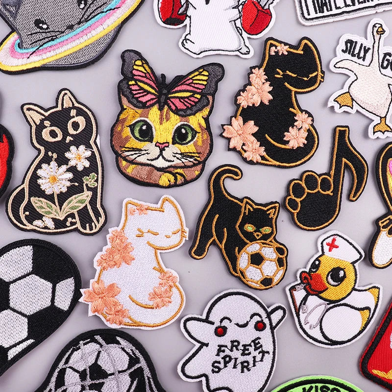 A collection of embroidered cartoon animal patches featuring cats, a bat, and other cute characters.