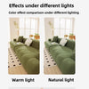 Comparison of a green sofa slipcover under warm light and natural light.