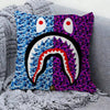 A decorative pillow cover featuring a bold print of a purple and blue monster face with large eyes and a prominent tooth.