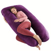 A woman is lying on a purple U-shaped memory foam pillow while relaxing.