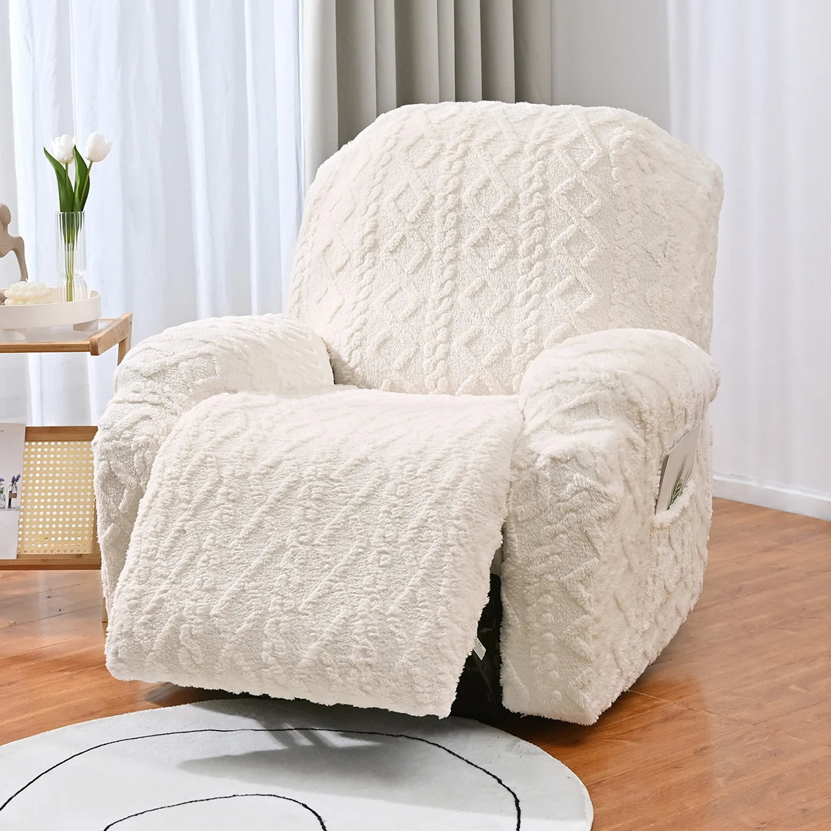 A cream textured sofa cover set featuring a diamond pattern on an armchair placed on a wooden floor.