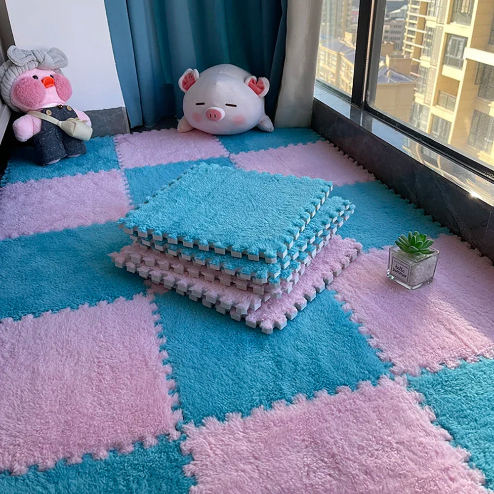 A pink and blue soft plush EVA foam play mat with tiles, a pink pig toy, and a green plant on the floor.