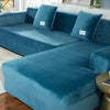 A deep teal velvet sofa cover for an L-shaped sectional with matching throw pillows.