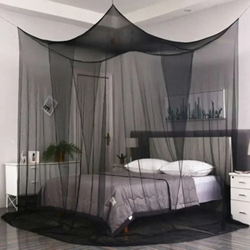 A large four-door mosquito net draped over a bed frame in a bedroom setting.