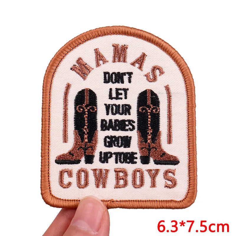 An embroidered patch featuring the text DON'T LET YOUR BABIES GROW UP TO BE COWBOYS with boot illustrations.