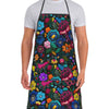 A man wearing a floral tatting apron over a white t-shirt.