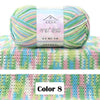 A ball of multi-colored gradient yarn is displayed on a knitted fabric background.