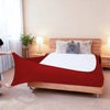 A red high-stretch elastic box spring cover is displayed on a wooden bed frame with fluffy pillows.