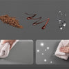 A brown granular product is shown next to a dark red liquid, with a hand holding a fluffy towel in the background.
