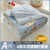 A blue and white striped lightweight quilt with a bear pattern is shown folded on a white surface.