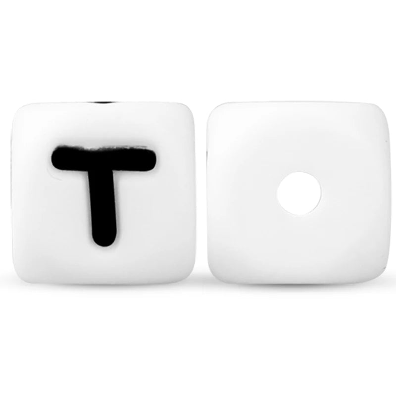 Two white silicone alphabet beads, one showing the letter T and the other blank.