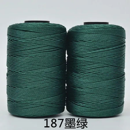 Spool of dark green hand knitting and crochet cord for crafting