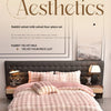 A pink rabbit velvet four-piece bedding set displayed on a bed with a dark gray headboard.