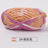 A ball of hand-dyed fabric strip yarn in shades of peach and lavender for crochet and knitting.