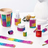Assortment of iridescent crystal rhinestone ribbons and craft supplies displayed on a white surface.