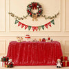 A red sequin rectangle table cover is displayed on a table, decorated with Christmas garlands and festive accents.