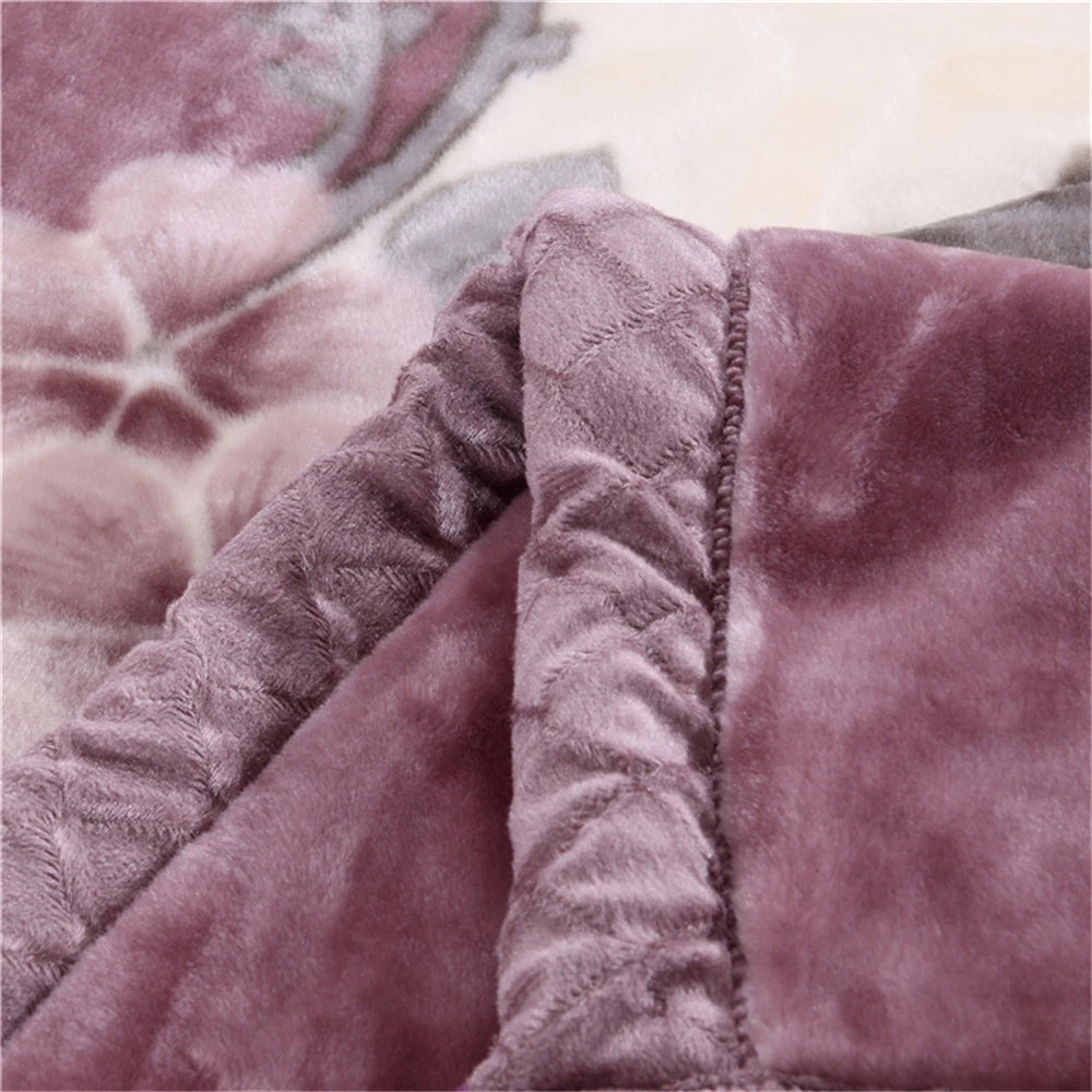 A close-up of a plush velvet blanket in rose and peony floral pattern, showing the soft texture and edge detail.