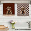 A set of two absorbent plaid kitchen towels featuring adorable baby goats.