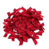 A pile of bright red satin ribbon bows for craft and decoration.
