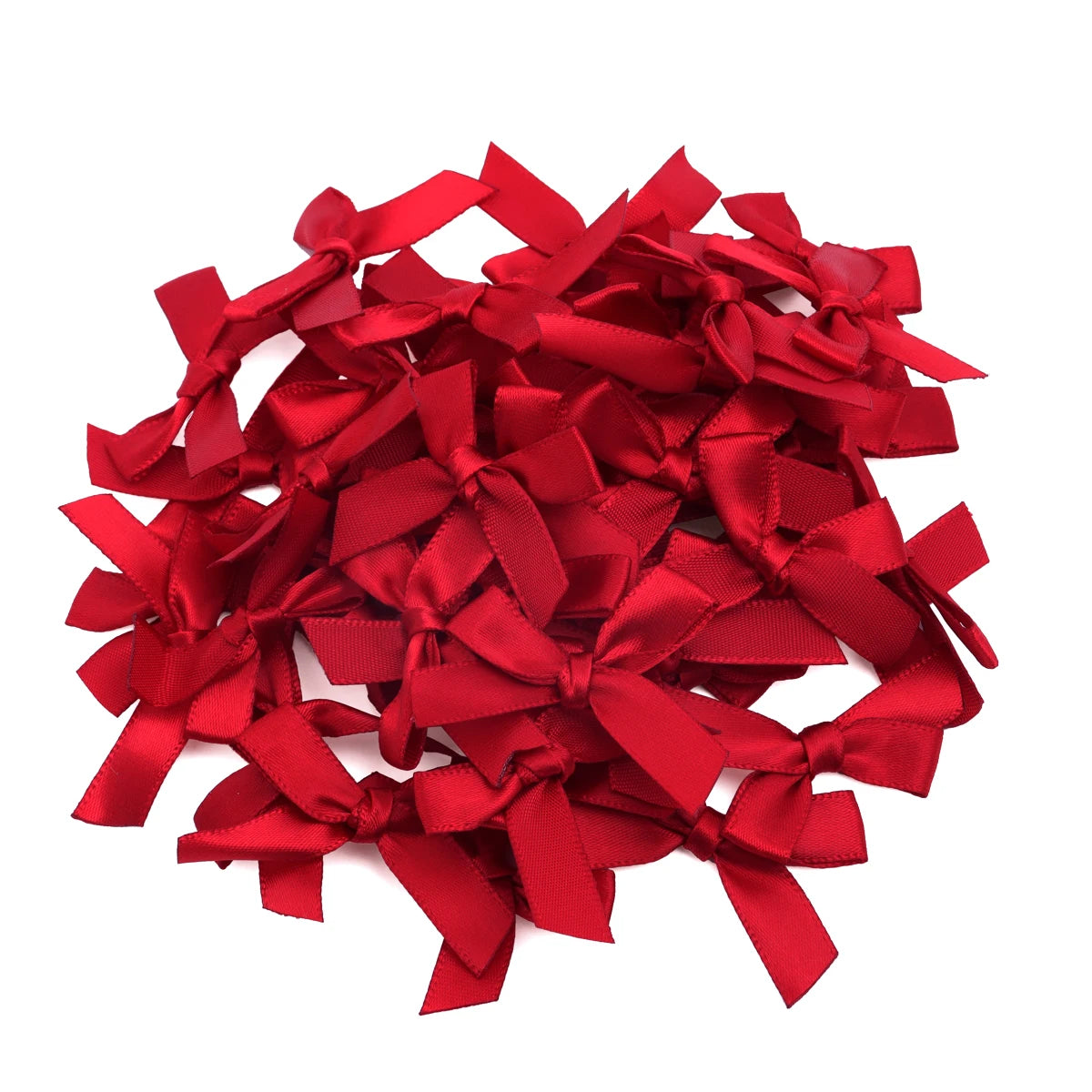 A pile of bright red satin ribbon bows for craft and decoration.