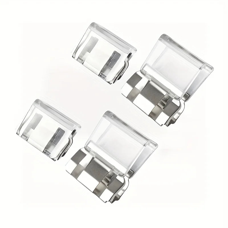 Four clear plastic invisible edge clips used for adjusting pants hems.