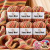 A set of six balls of gradient alpaca wool yarn in various colors and textures for knitting and crochet projects.