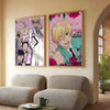 A framed poster featuring characters from Ouran High School Host Club with pink and yellow tones hanging on a light-colored w