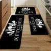 Black non-slip kitchen mats with white cutlery designs placed on a light wood floor.