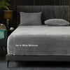 A gray luxury velvet bedding set featuring a fitted sheet and pillows on a bed.