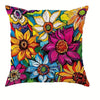 A decorative pillow cover featuring a vibrant, colorful floral pattern with yellow, pink, purple, and blue flowers.