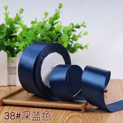 Roll of dark blue satin ribbon for gift wrapping and DIY crafts
