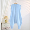 Light blue cotton striped sleeping bag for children hanging on a wooden hanger