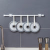 Silver curtain rod hooks with circular silicone grips mounted on a gray wall