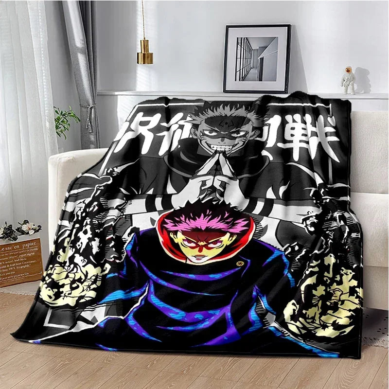 A black and white graphic throw blanket featuring characters from Jujutsu Kaisen anime
