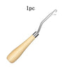 A single plastic latch hook tool with a wooden handle for crochet and crafting.