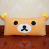 A fluffy orange Rilakkuma plush bed pillow and sofa cushion with black eyes.