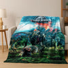 A blanket featuring a Jurassic World dinosaur scene with dinosaurs and a dramatic sky.