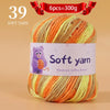 A ball of 39 soft yarn strands in shades of orange and yellow for hand knitting.