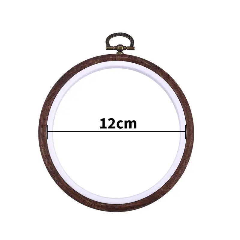 Round wooden embroidery hoop with a light-colored fabric inside